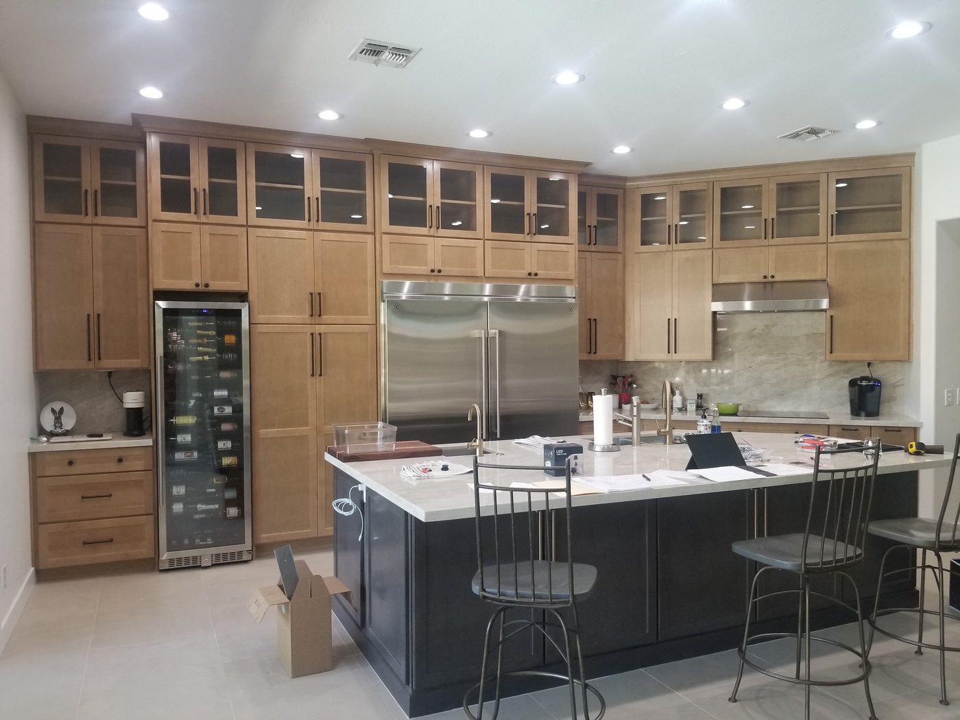 Open-concept kitchen with wine tower and wood flooring